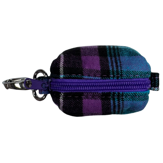 The top view of a plaid poo bag holder with purple zipper and keychain for easy attachment to a lead.
