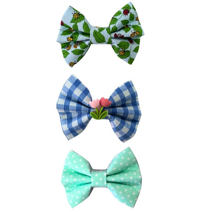 Three colourful pet bow ties with a tulip on the middle blue gingham bow