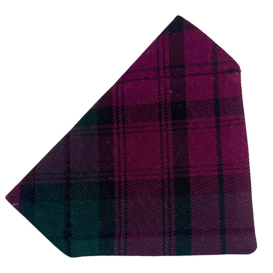 Tartan fabric dog bandana with purple and green pattern .