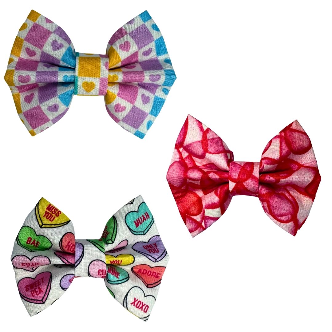 Three colourful dog bows or bow ties themed around love