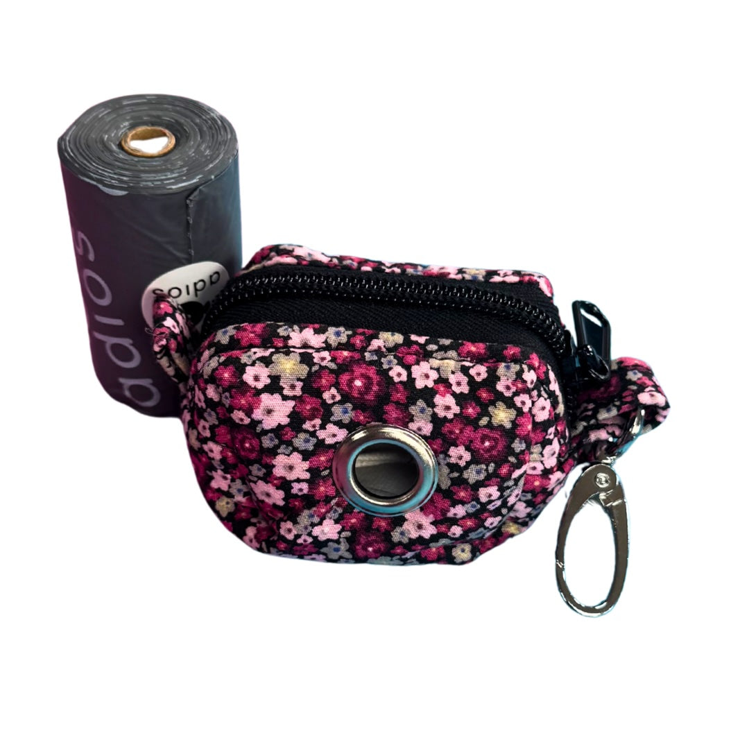 Cherry Blossom Floral-patterned waste bag holder with a roll of black adios waste bags on a white background