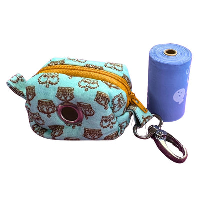 Dog poo bag holder and clip with a crown pattern and a roll of blue adios poo bags 