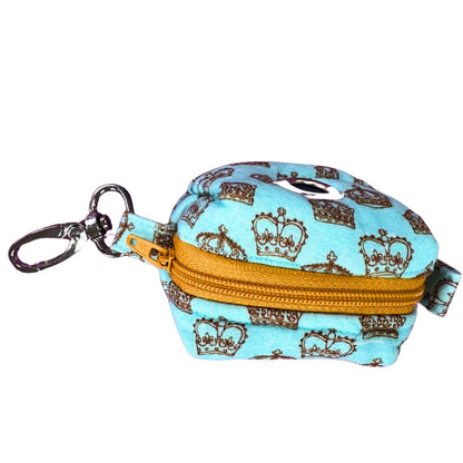 Top view of the royalty poo bag holder, a small pouch with crown pattern and gold zipper on a white background