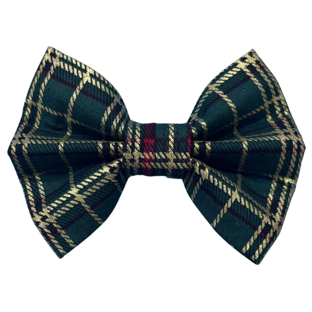 A green tartan Christmas dog bow with a plaid red and gold pattern