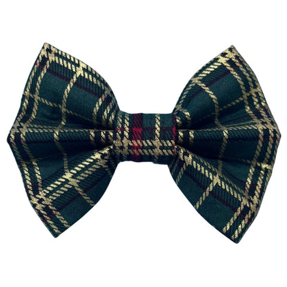 A green tartan Christmas dog bow with a plaid red and gold pattern
