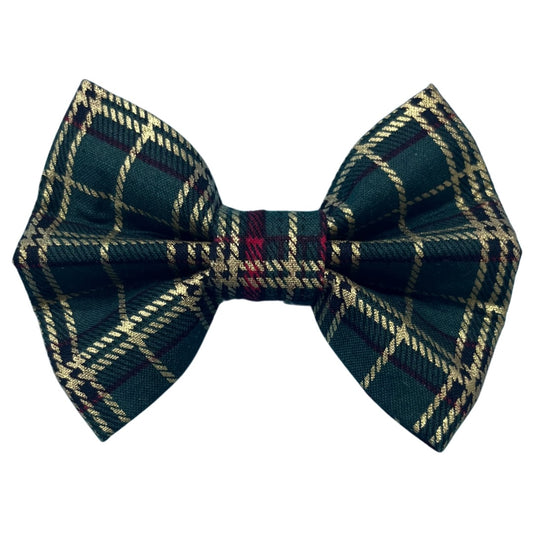 A green tartan Christmas dog bow with a plaid red and gold pattern