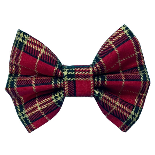 A red tartan dog bow tie with a plaid black and gold pattern